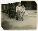 Portrait of Hans and Walter Gundelfinger wearing traditional German shorts.