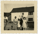 The Loeb family stands outside a warehouse in Halsenbach, Germany.