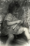 A three year old girl plays with a utensil in Iasi, Romania.