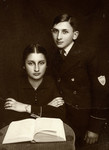 Studio portrait of Lonek (Leon) Halberstadt and his sister Yocheved (Jadza) on the occasion of his bar mitzvah,