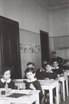 Children sit at their desks in a classroom in an elementary school in Milan.