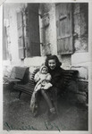 Annie Spira holds her baby brother Serge after arriving in Switzerland.