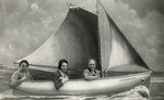 Studio portrait of three sisters on a pretend boat in Scheveningen, Holland.