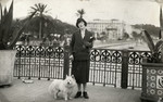 Camille Spira poses on a street in Vichy with a dog.