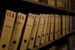 A row of boxed files in the International Tracing Service's Incarceration Camp Documents Unit containing 11 binders of the files of Roma at Auschwitz.