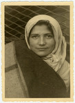 Rachel Krygier, a passenger on the ship the Exodus, peers out behind a blanket [probably in Haifa harbor].