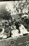 The Diamant children pose in a garden with their nanny.