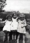 Three young girls pose together in the Foublaines children's home.