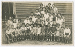 Class portrait of elementary school children outside of the [school].