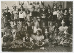A group portrait of children dressed up in [Purim] costumes.