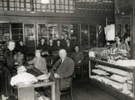 The staff of the Somlo knit wear store in Budapest, Hungary assists a Polish prince and his wife who came to purchase goods.
