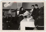 Esther Ass receives a certificate from the ORT school in the Beit Bialk displaced persons' camp.