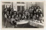 Religious Jewish women gather around a table for a celebration in the Bad Gastein displaced persons' camp.