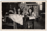 Two girls work at sewing machines at an ORT school in the Beit Bialik displaced persons' camp in Salzburg, Austria.