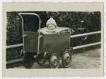 Close-up picture of a young child in a baby carriage in prewar Butrimonys.