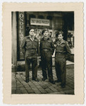 Three Jewish Brigade soldiers, all former Mauritius internees, stand outside a store in Eindhoven.