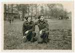 Two Jewish Brigade soldiers pose together on a grassy field in Eindhoven.