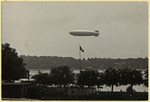 The Hindenburg blimp flies above a Nazi flag.