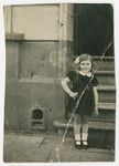 Six-year-old Fanny Fogel stands outside the steps of a building in Antwerp.