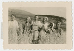 The Gruenberg sisters stand in a field with friends.