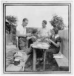 Four Romanian Jewish youth prepare a picnic.

Among those pictured are Anna and Miriam Segal.