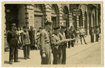 Members of the Four Power International Patrol of Russian, French, British, and American military police gather on a street in Vienna.
