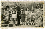 Group portrait of Jewish children wearing costumes [probably for a Purim celebration].