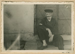 Close-up view of a bearded man sitting on a doorstep in what probably is the Deblin-Irena ghetto.