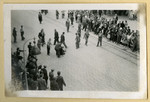 Bystanders watch Jews as they are rounded up and attacked on a street in Lvov.