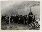 A group of the civilians who had been living in a mine stand under a white flag of surrender after arrival of Ninth U.S.