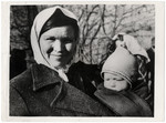 Close-up portrait of a Russian woman and infant awaiting repatriation.