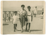Nacha Gross walks along the sea shore in Nice acompanied by two of her sons, Fred and Leo.