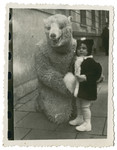 Halina Reinberg poses with someone dressed in a bear costume shortly before leaving Poland with her parents.