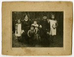 Moshe and Krjndel Mirla family pose in their garden with three of their children.