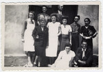 Volunteer resident social workers and OSE staff pose for a group portrait  in the Rivesaltes internment camp.