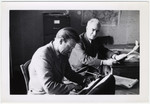 Maurice Levitt (right), a member of the Frankfurt Jewish GI Council, and his secretary work in their office in Bad Nauheim.