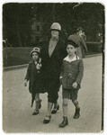 Betty and Harry Straus walk down a street with their Aunt Betty.