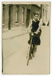 Harry Straus rides his bicycle down a street of S'Heenrenberg.
