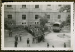 Jewish displaced persons wait outside a building in the [Graz displaced persons camp].