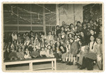 Group portrait of children, some wearing costumes, in the Yesodei HaTorah school in Antwerp.