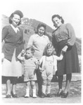 Jewish women and their children pose outside in the Morgins refugee camp.