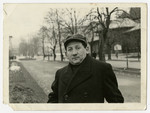 A member of the Rabinowitz family stands on a street in prewar Otwock..