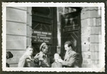 Rosian Bagriansky kids around with British soldiers outside the entrance to a building in the Graz displaced person's camp.