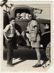 Partisan leader Zus Bielski stands next to his first truck with his wife, son, and brother in postwar Israel.