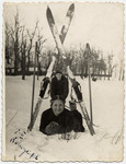 Sonia Boldo (later Bielski) lies in the snow underneath her skis.