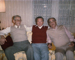 The Bielski brothers pose on a couch with a friend.