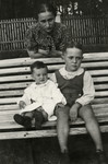 Leah Kaplan poses with her two children, Shalom and Yehudit, on a park bench in prewar Kaunas.