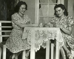 Yehudit Steiglitz,left, sits at a table and plays cards with her friend Katy.