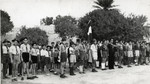 Children stand at attention during a flag raising ceremony at the Ayindram Betar summer camp.