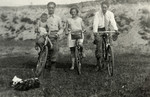Michel Werber rides on the handlebars of his father's bicycle accompanied by his aunt and uncle.